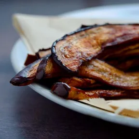 Photo of eggplant-based bacon piled on a plate