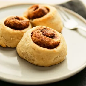 Photo of homemade plant-based cinnamon rolls on a plate