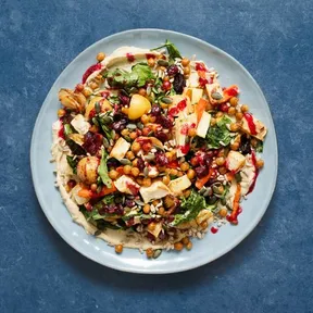 Photo of a hummus dish with roasted tuber vegetables