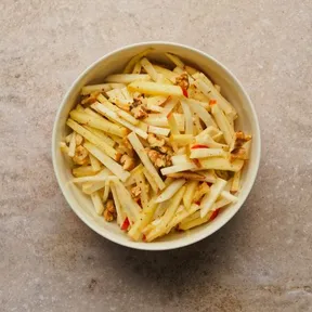 Photo of a bowl of celeriac ice cream salad with apple and walnut