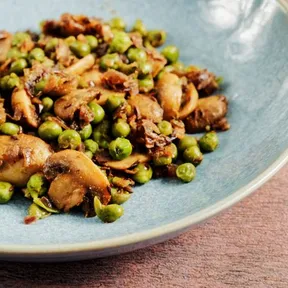 Photo of mutter masala with mushrooms on a blue plate