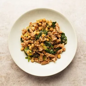 Photo of a plate of whole wheat pasta with chickpeas, spinach and za'atar