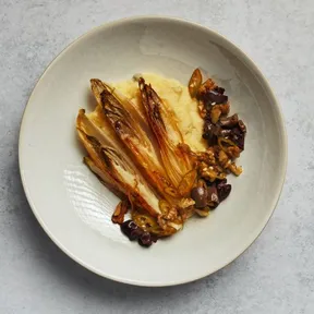 Photo of creamy polenta with caramelized chicory and walnut-olive salsa