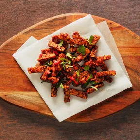 Photo of spicy sticky tempeh on a baking sheet