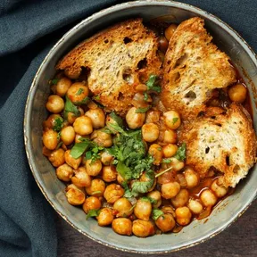 Photo of Tunisian chickpeas stew  (Lablabi) with toasted bread and chopped cilantro