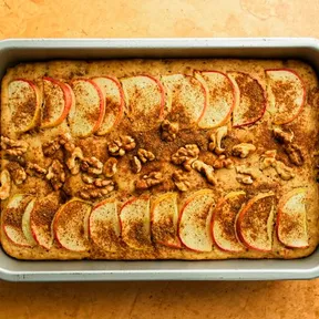 Photo of a vegan applesauce cake with pieces of walnut and cinnamon