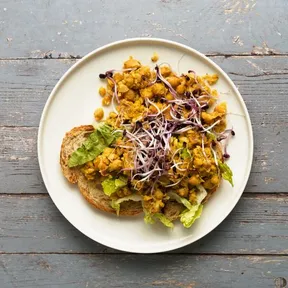 Scramble of chickpeas on a slice toasted bread with lettuce