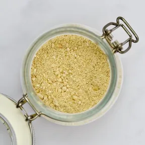 Photo of vegan parmesan in a small glass jar