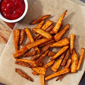 Photo of fries made from sweet potato with a bowl of ketchup