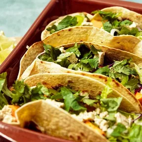 A baking dish with vegan sweet potato black bean tacos